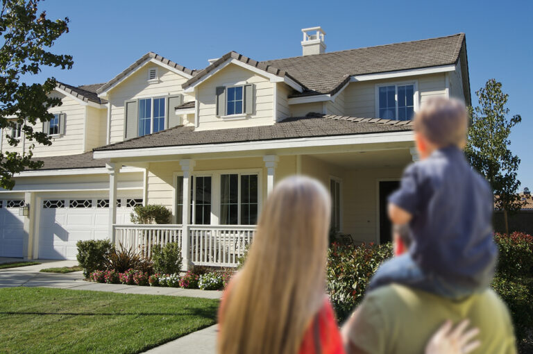 Young Family Looking at a Beautiful New Home